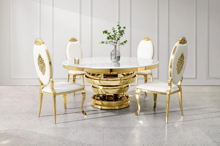 Elegant dining set with a 64" round marble top table and gold base, surrounded by four white and gold chairs in a modern room setting.
